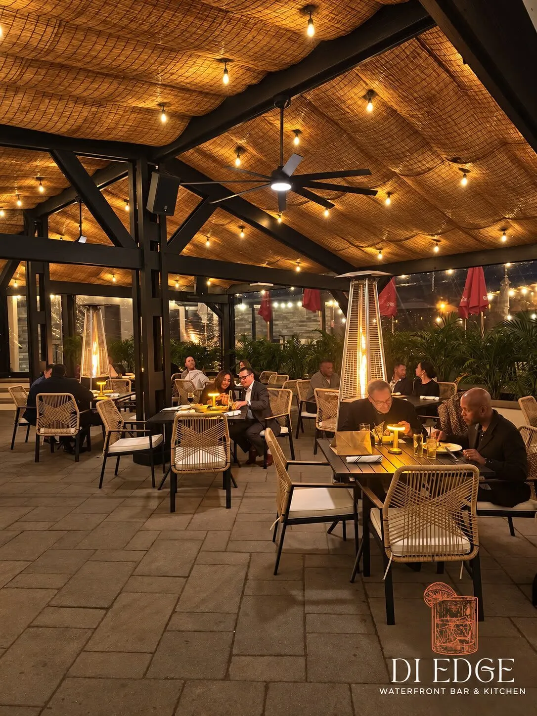 Guests dining under a woven canopy of string lights