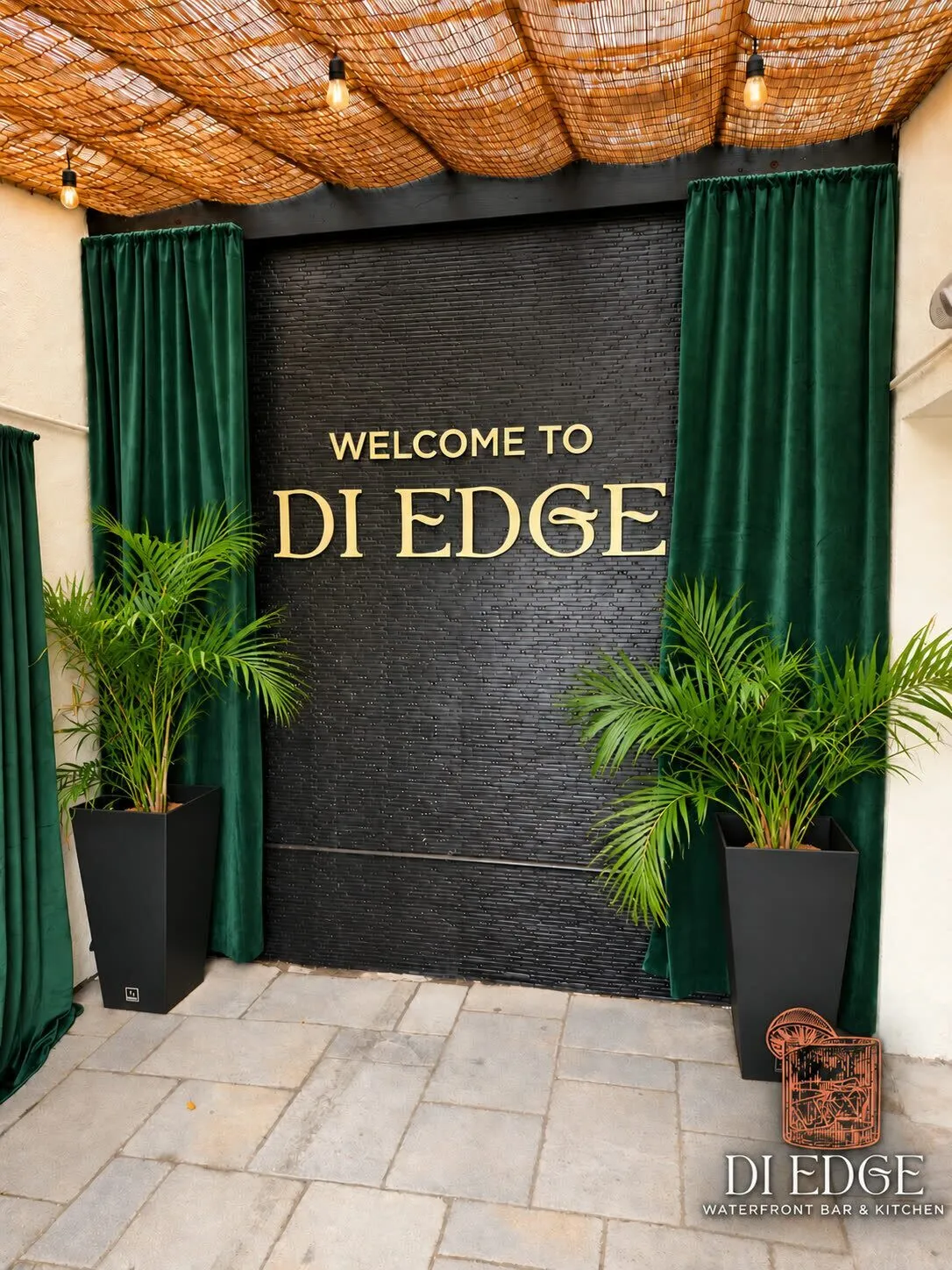 Gold lettering on black stone: Welcome to Di Edge